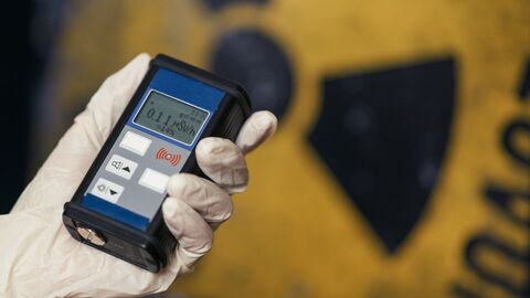 Eine Person in Schutzausrüstung überprüft Strahlenwerte.